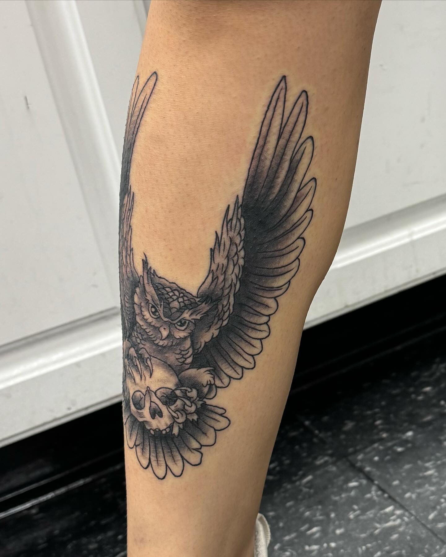 Owl black and grey tattoo on the forearm by Cory Perry-Servellon