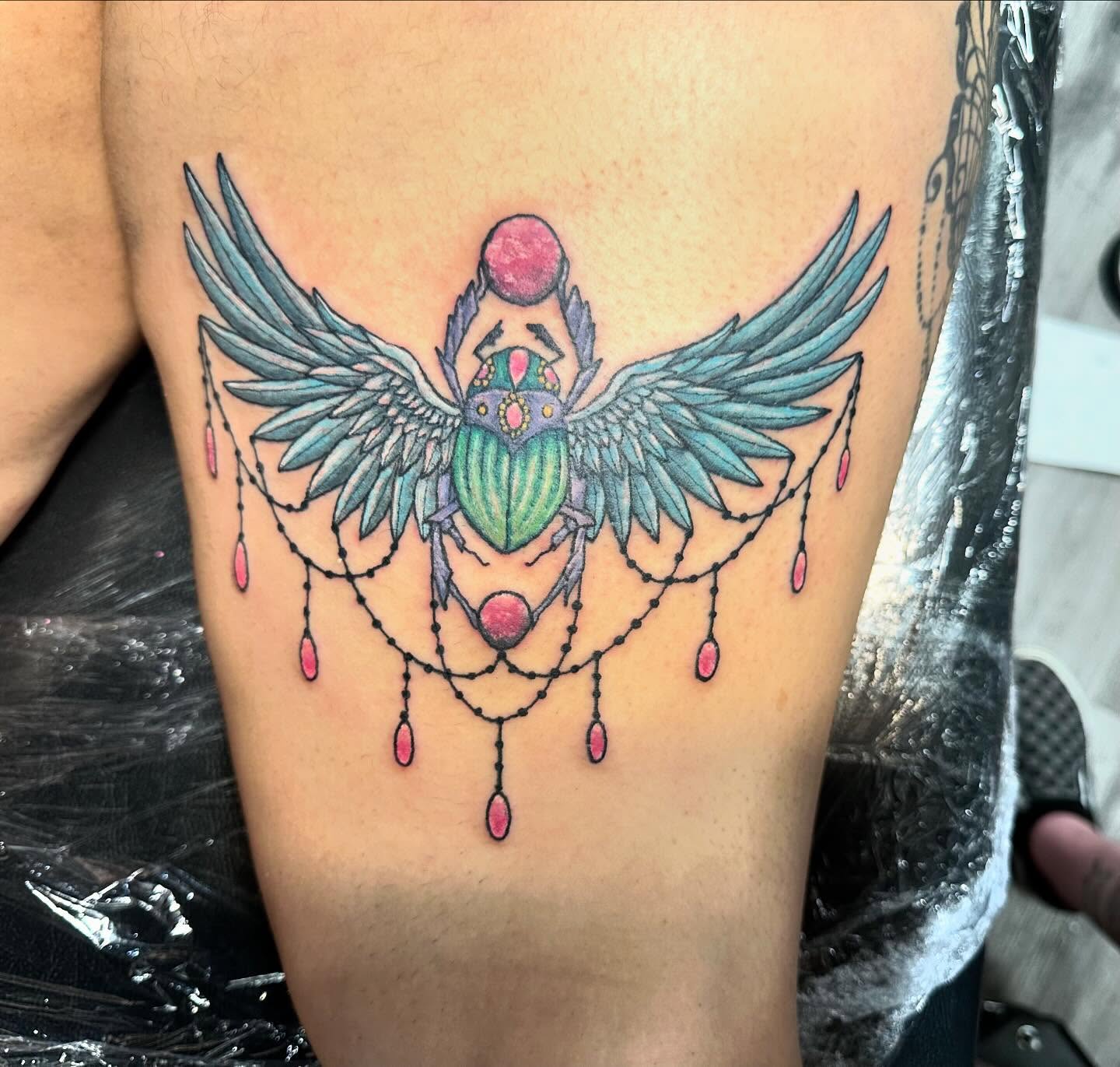 Scarab beetle new school tattoo on the thigh by Madeline, Akron, Ohio