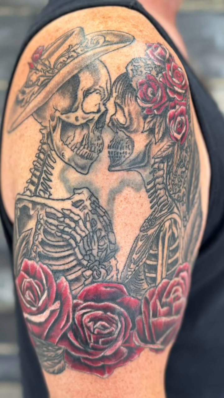 Skeletons kissing with roses realism tattoo by Chris Allen Taylor