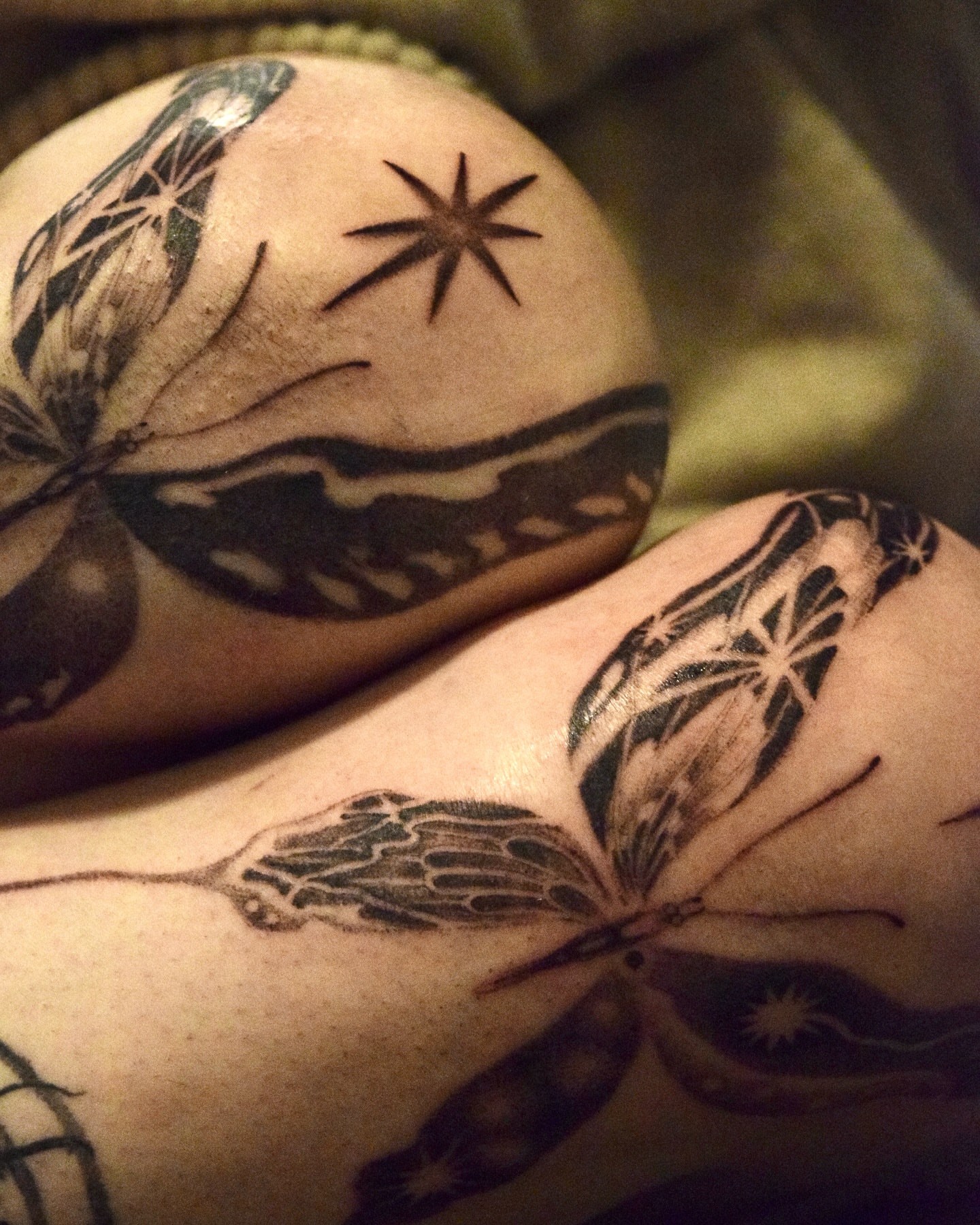 Butterfly and star black and grey tattoo on the forearm by Stella Oh