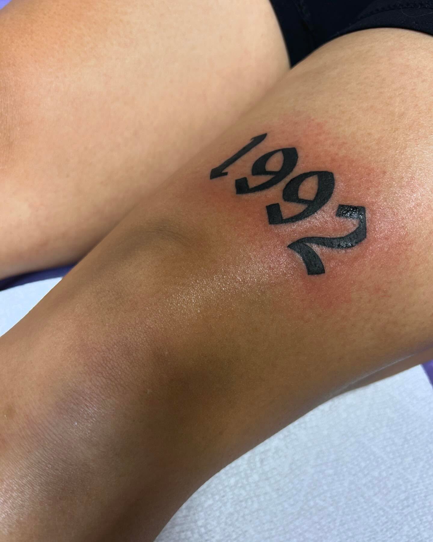 Numbers lettering script tattoo on the forearm by Tattoo Artist
