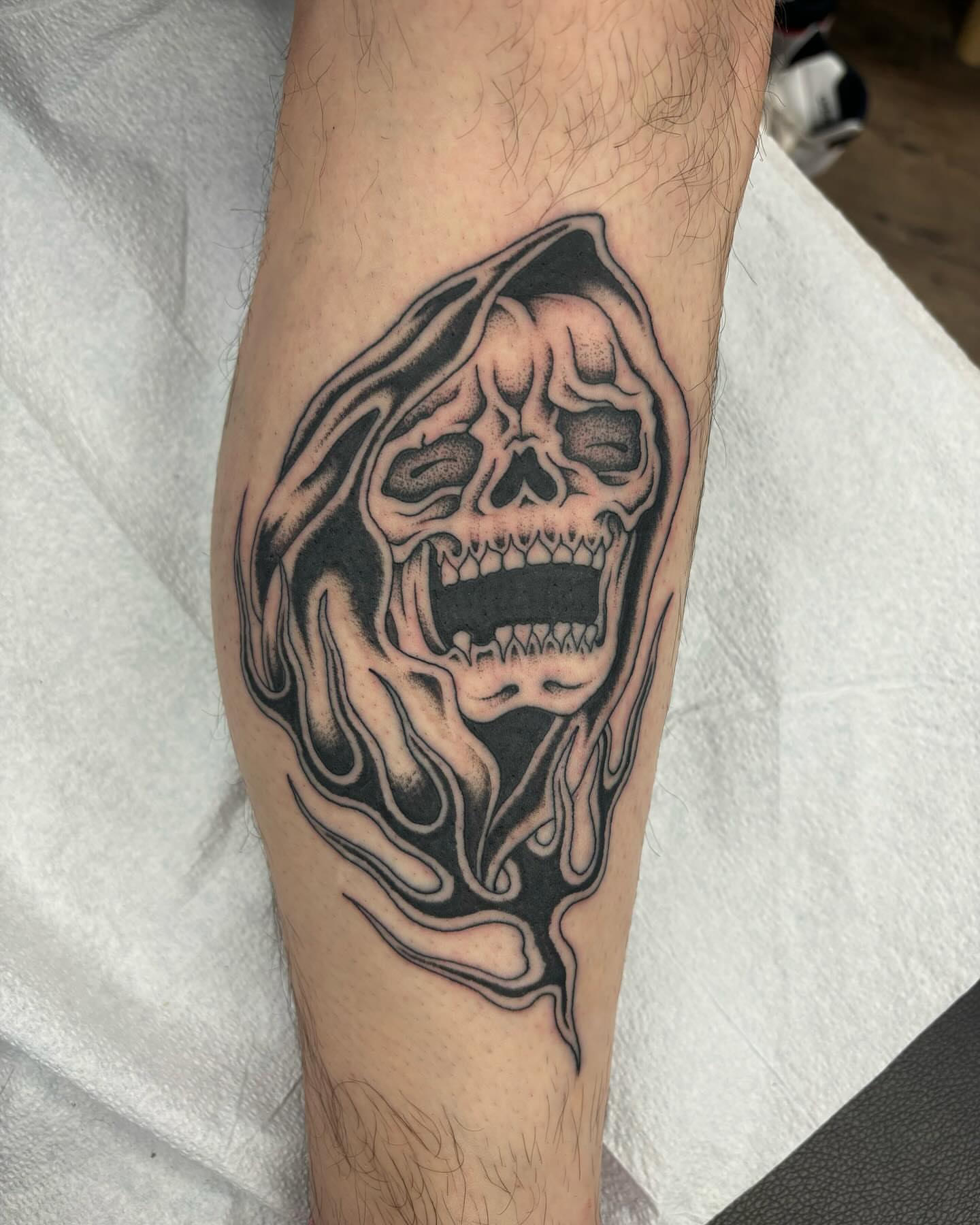 Melting skull dark realism tattoo on the forearm by Brayden P Tattoo