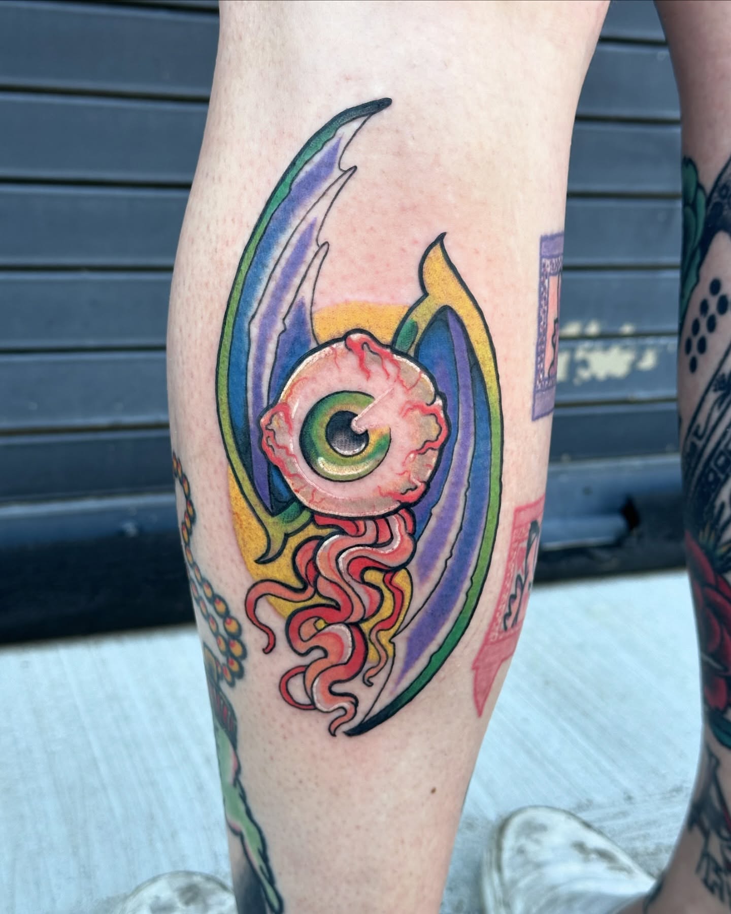 Eye with flame new school tattoo on the calf by Sarah Bobby, Houston, Texas