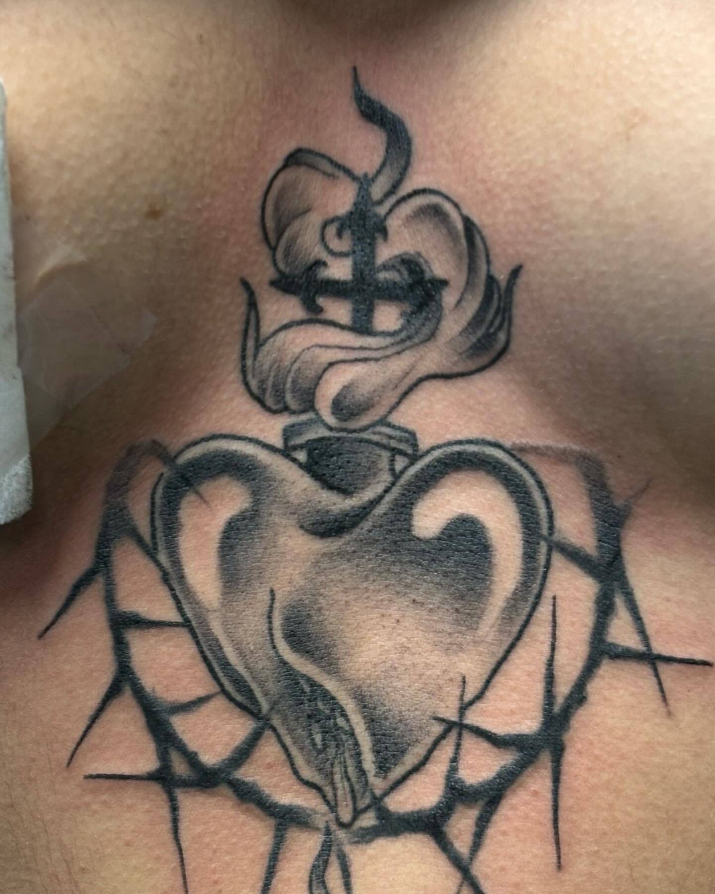Heart with crown black and grey tattoo on the chest by Ares Rhodes