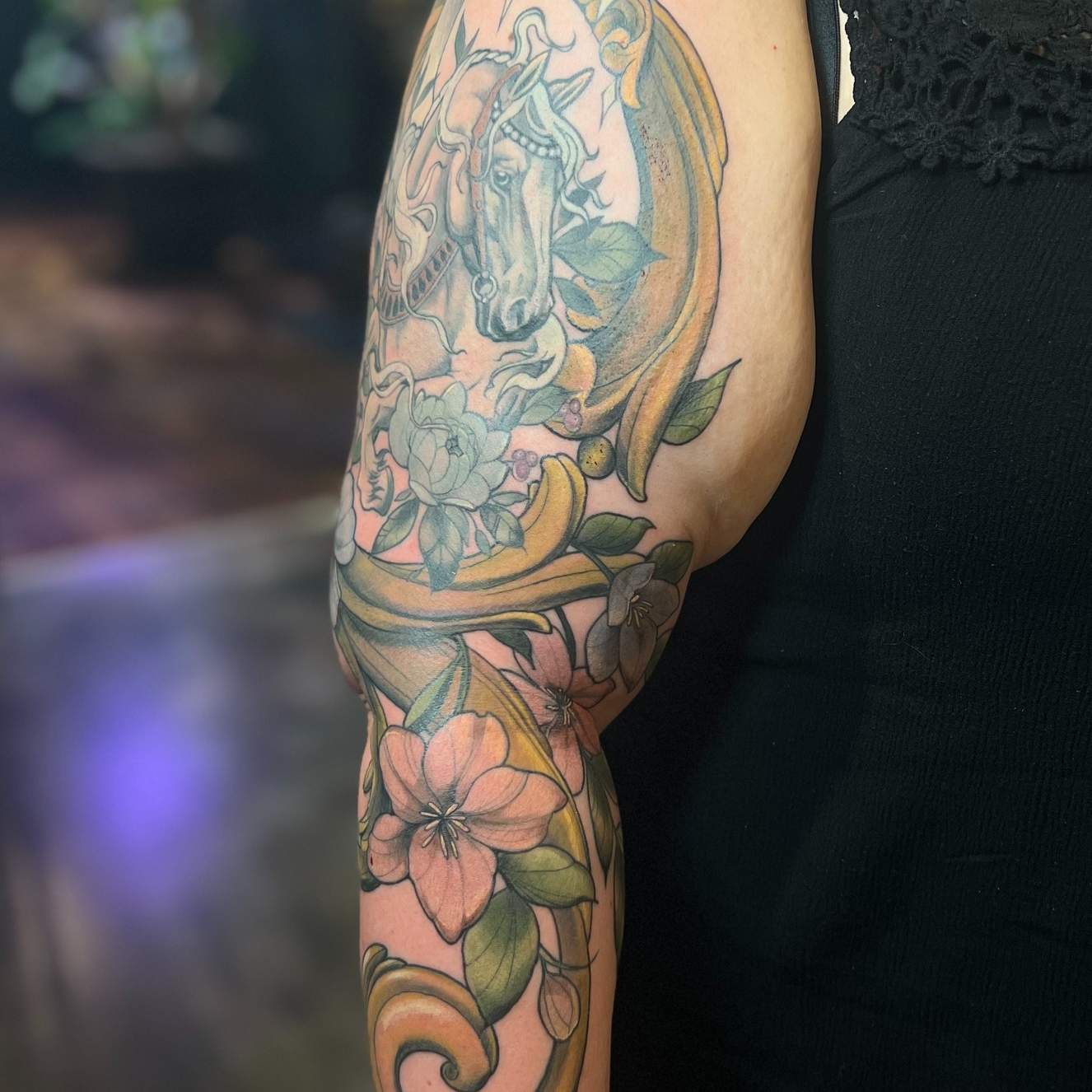 Horse and floral new school tattoo on the forearm by Michelle Radz
