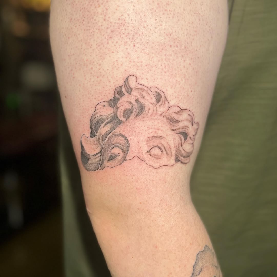 Sculpture bust surrealism tattoo on the forearm by Emma Allison