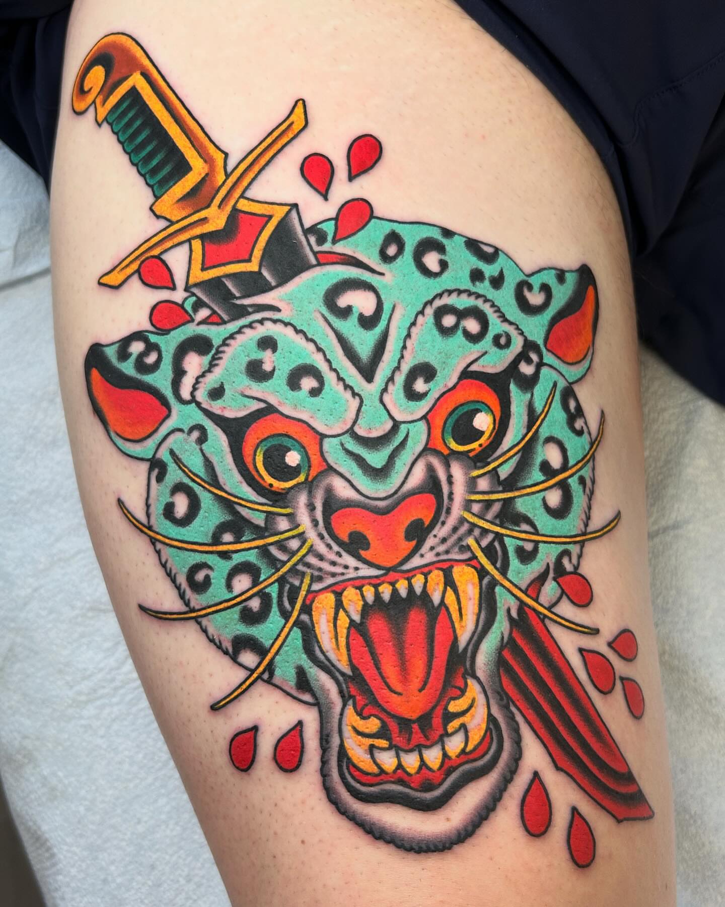 Jaguar head American traditional tattoo on the thigh by Adam Mir