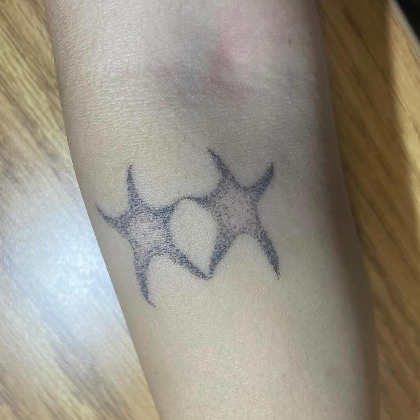 Starfish dotwork tattoo on the forearm by hana