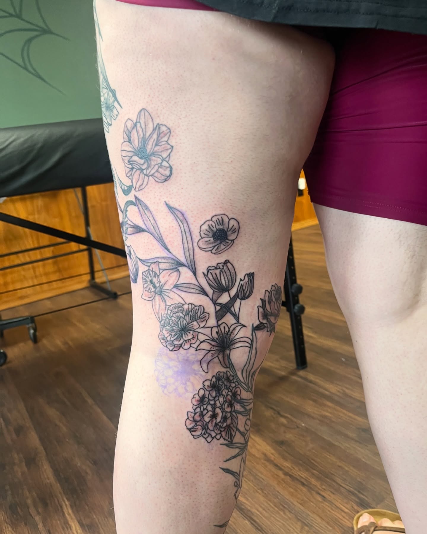 Floral bouquet black and grey tattoo on the thigh by Michelle