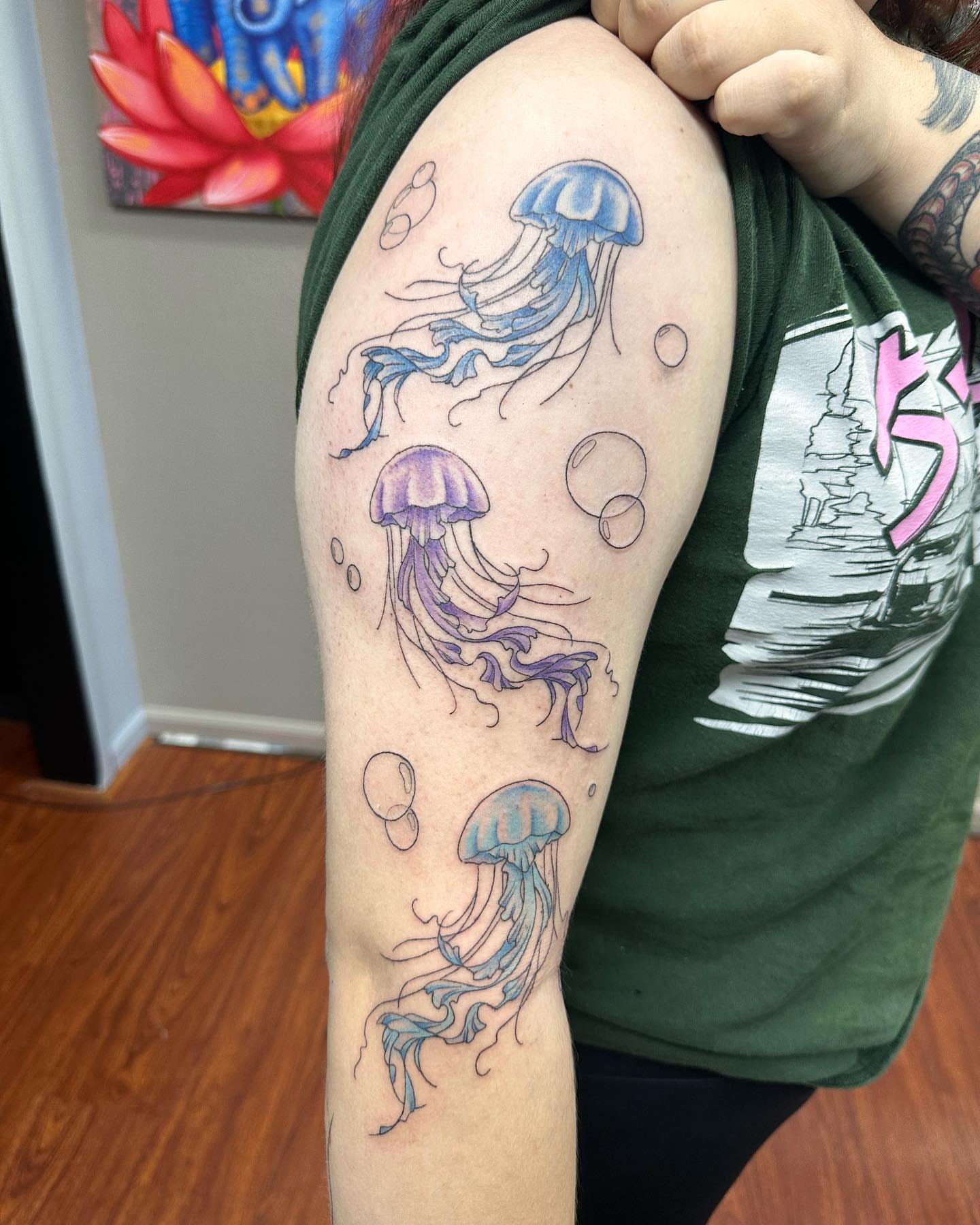 Jellyfish watercolor tattoo on the upper arm by Kat π