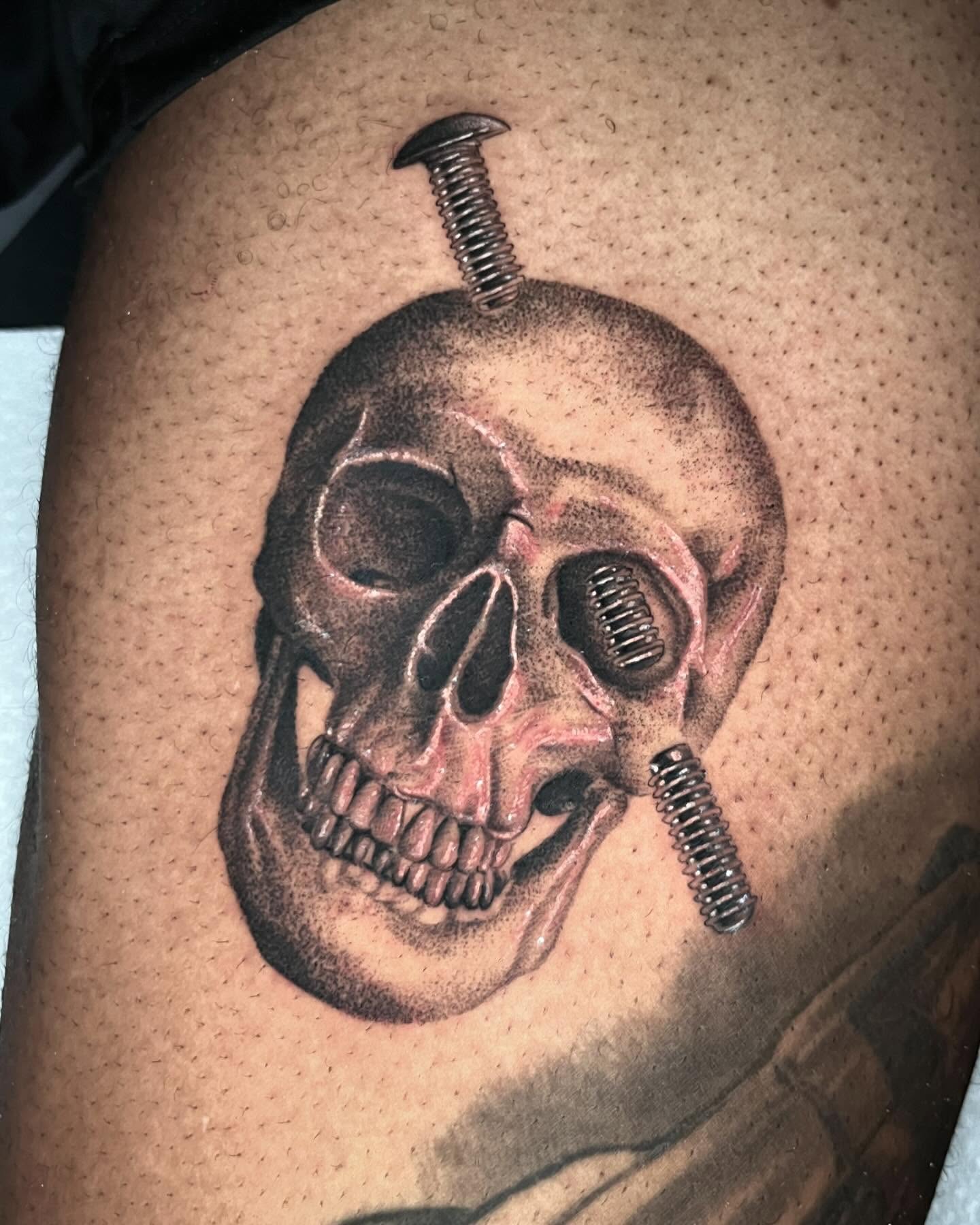 Skull with screws realism tattoo on the thigh by Single Needle ๐ชฉ