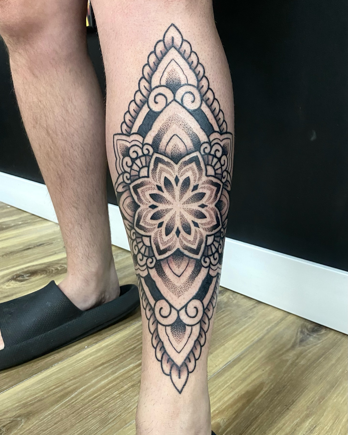 Mandala dotwork tattoo on the calf by Rose Ulinski