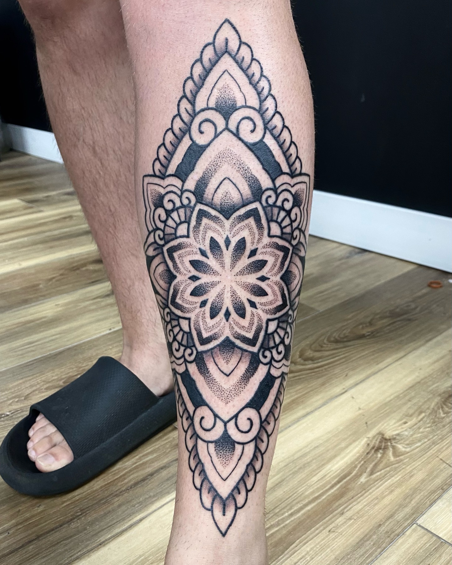 Mandala dotwork tattoo on the calf by Rose Ulinski
