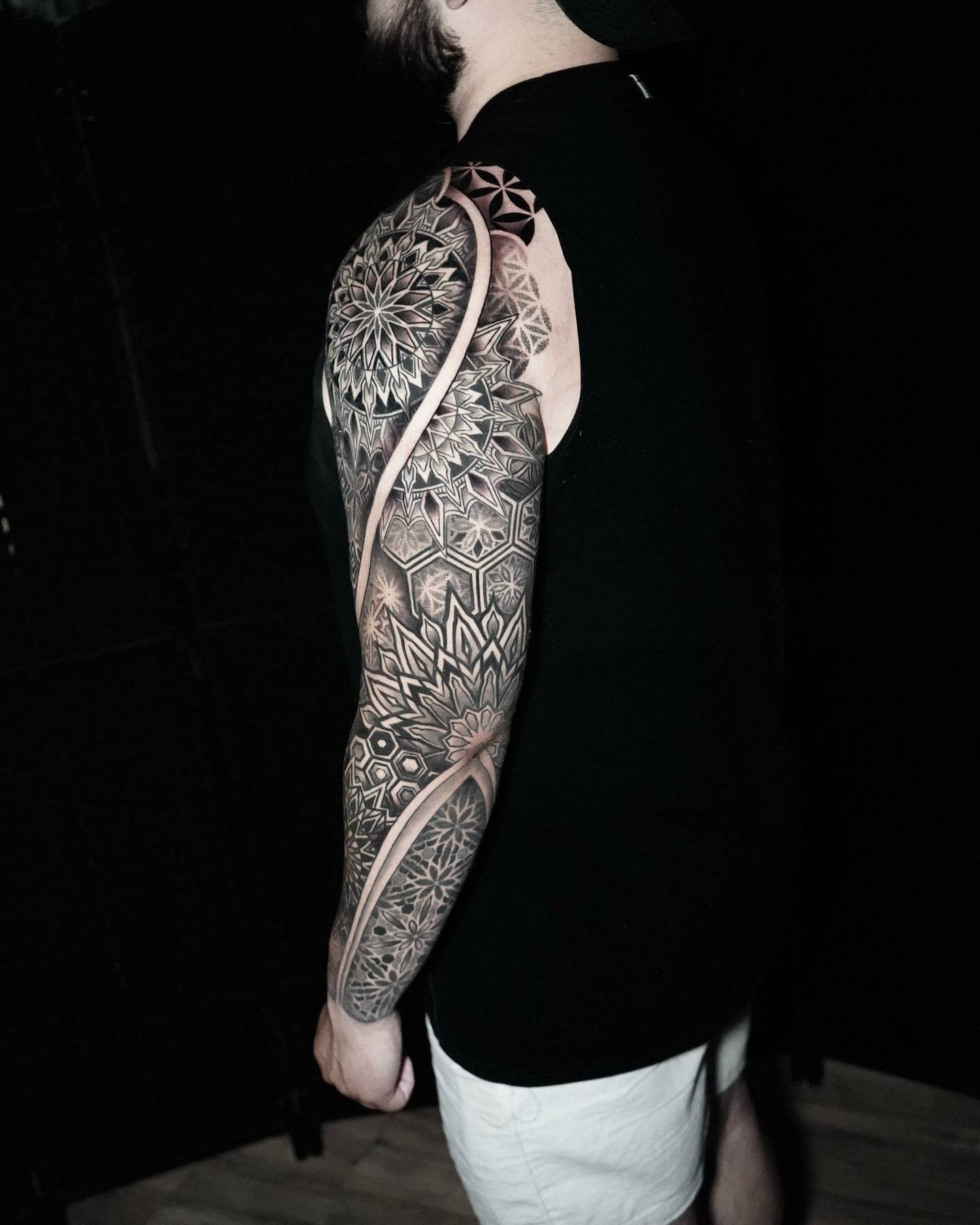 Geometric mandala geometric tattoo on the upper arm by Eric Hare