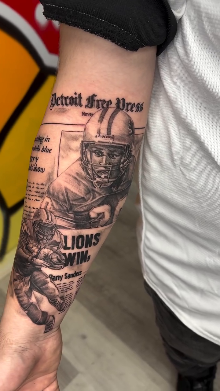 Detroit Lions player and newspaper headline realism tattoo on the forearm by Antonio