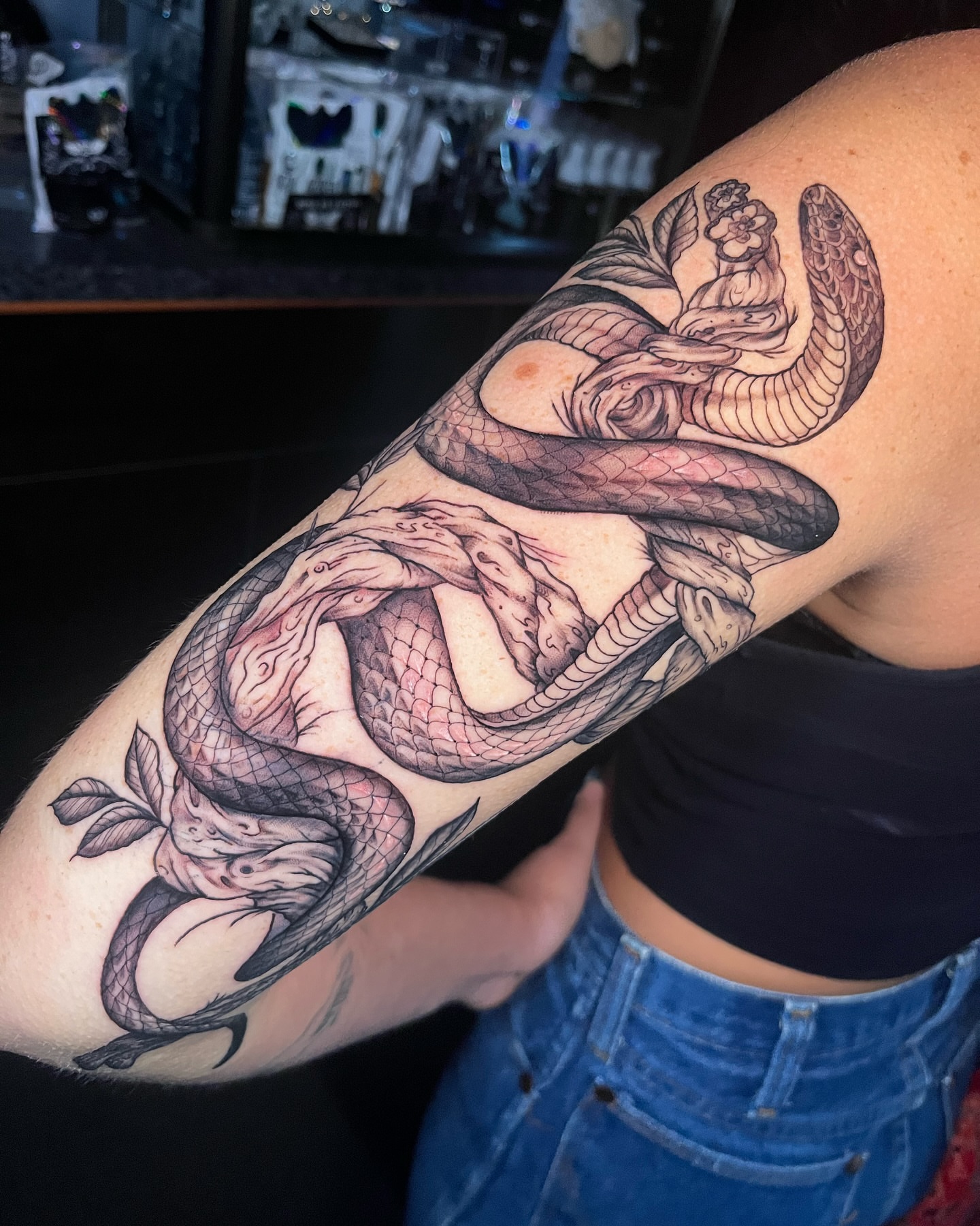 Snake and peony realism tattoo on the forearm by James Jurado
