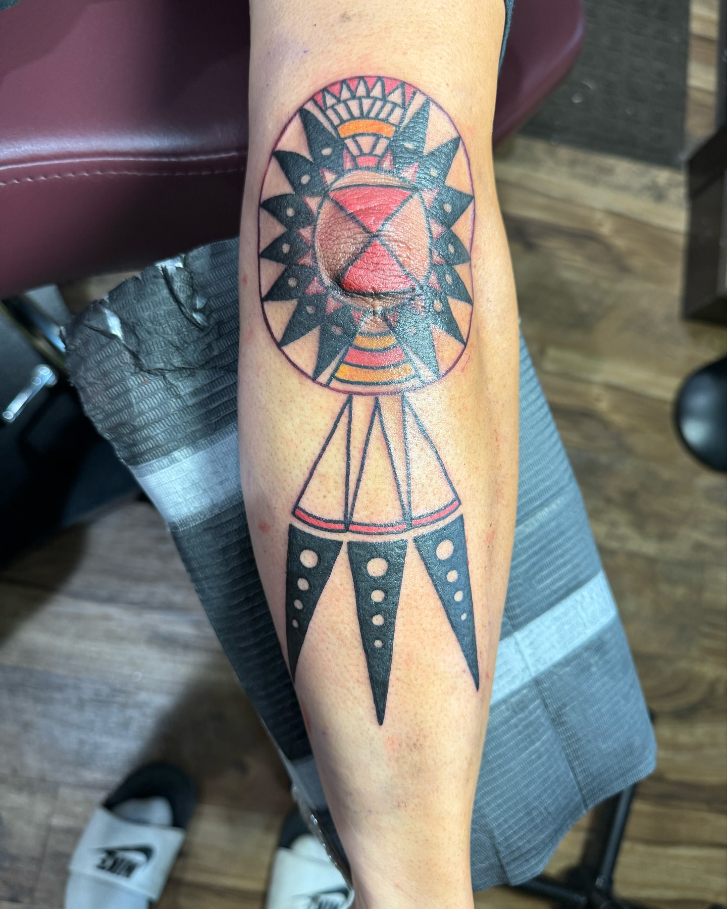 Geometric sun geometric tattoo on the forearm by Minneapolis