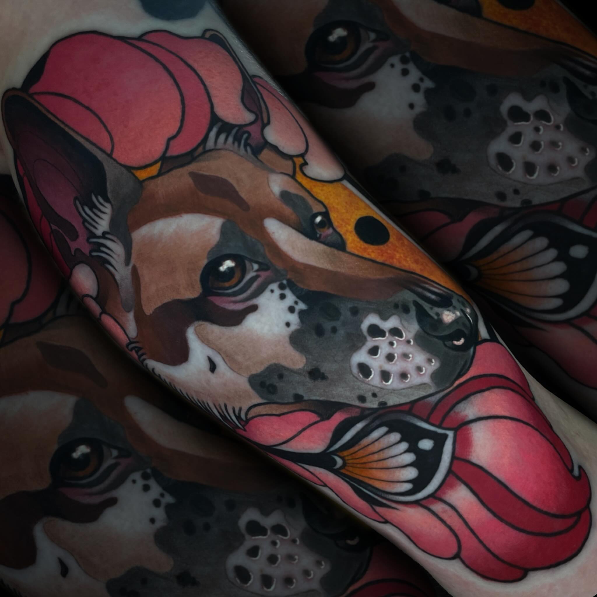 Dog with flowers American traditional tattoo on the forearm by Nathan Mickle