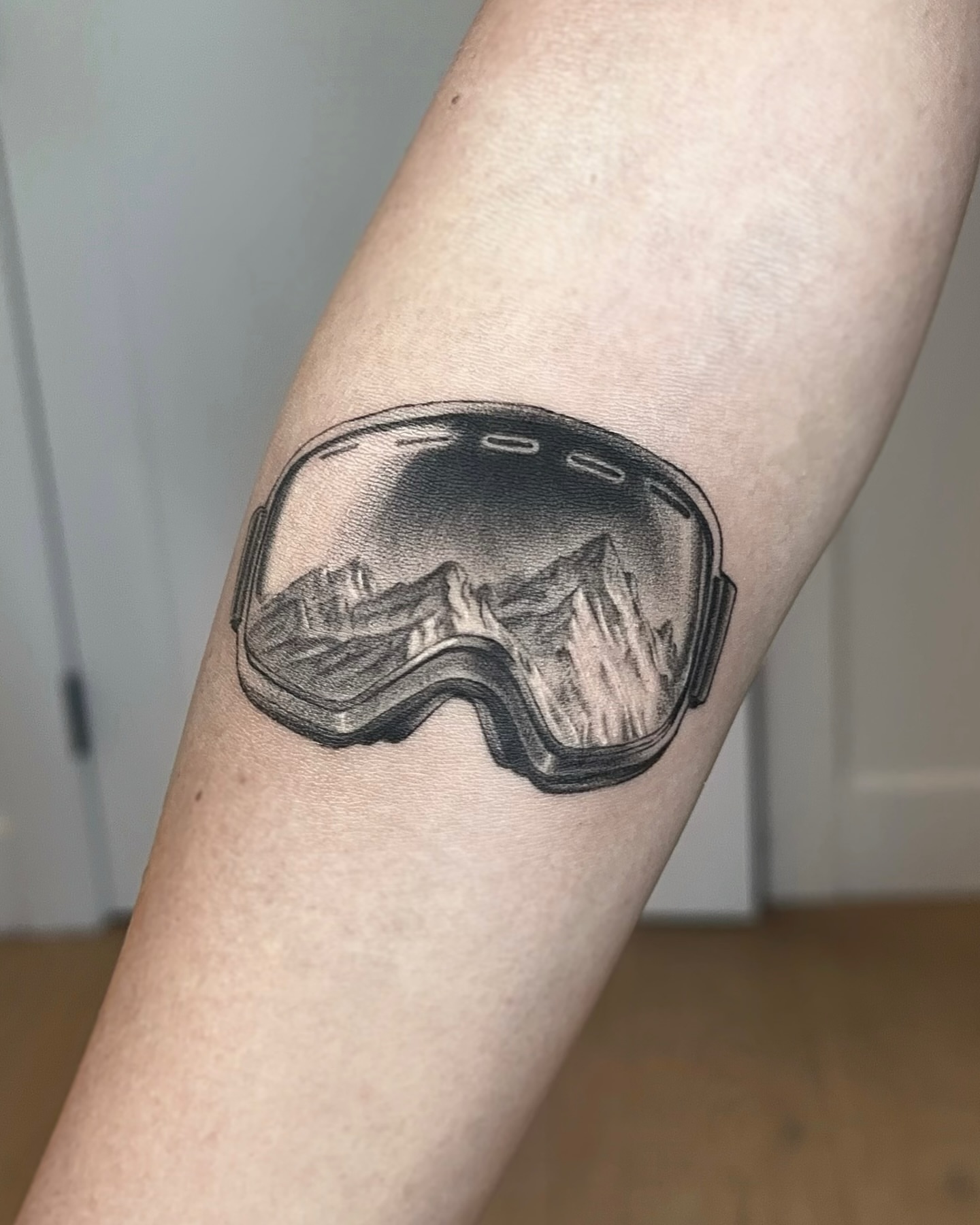 Ski goggles realism tattoo on the forearm by Oxana