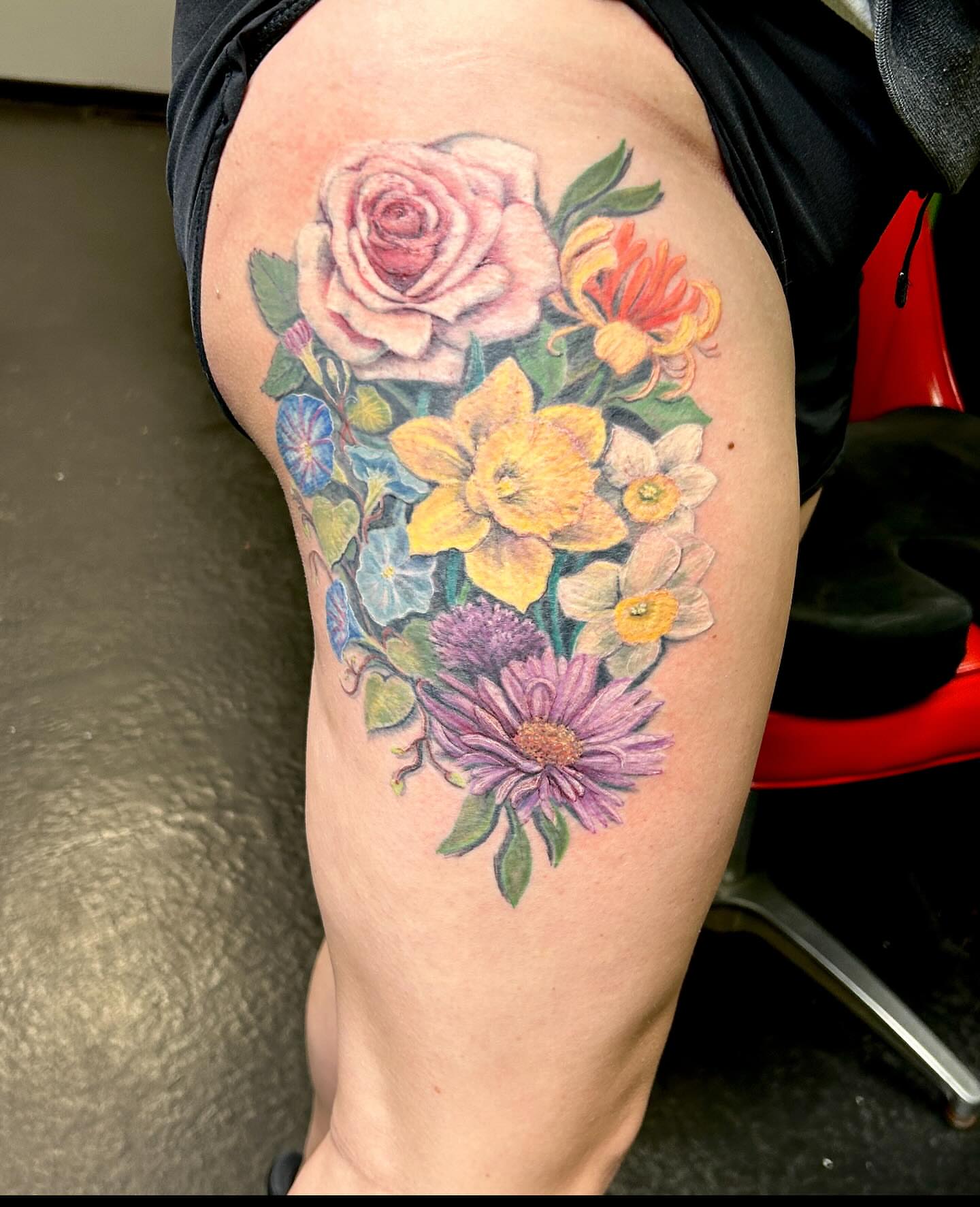 Floral bouquet realism tattoo on the thigh by B Hendrix, Cuyahoga Falls, Ohio