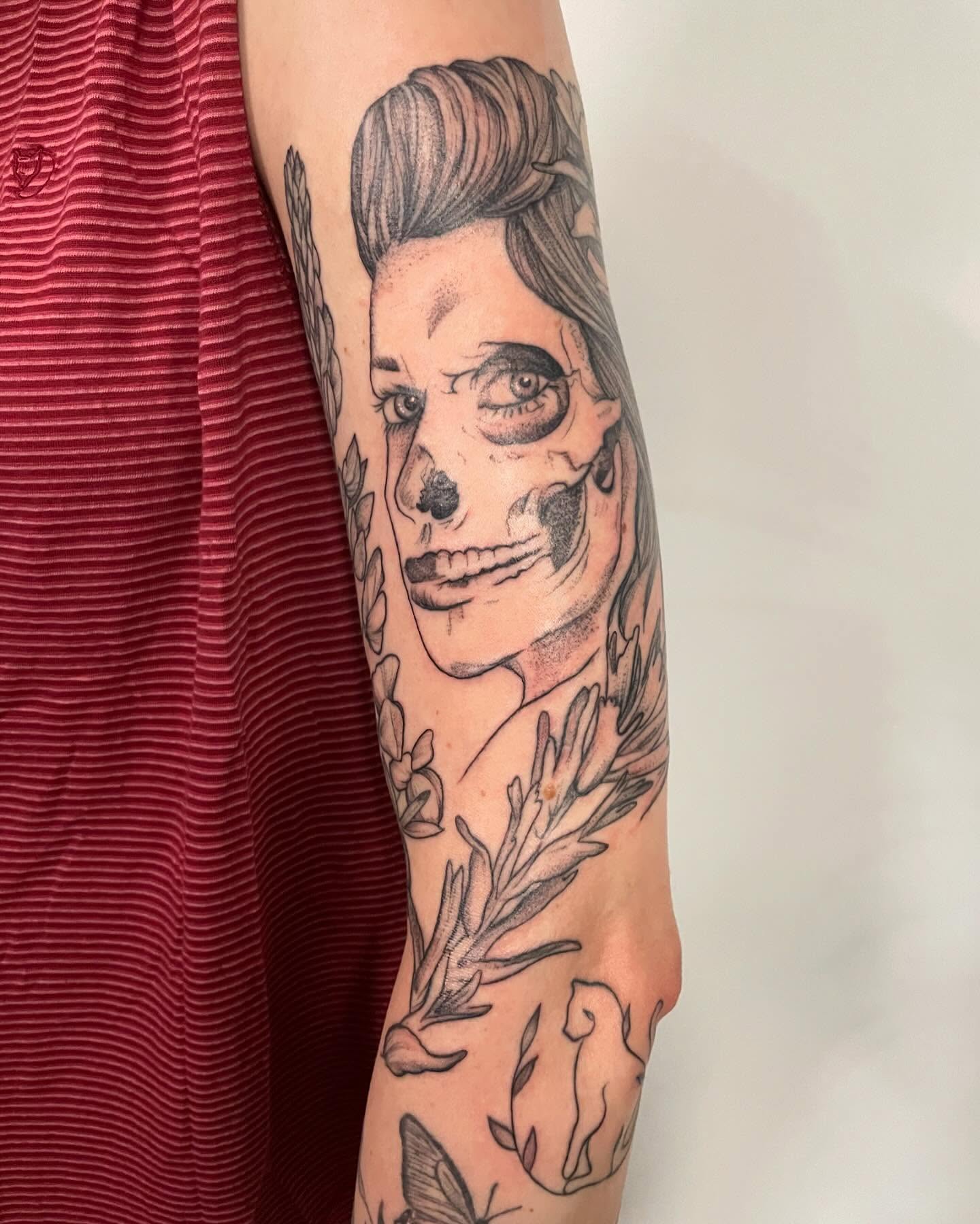Skull with floral elements realism tattoo on the forearm by Christen Wolfe CA Tattooer