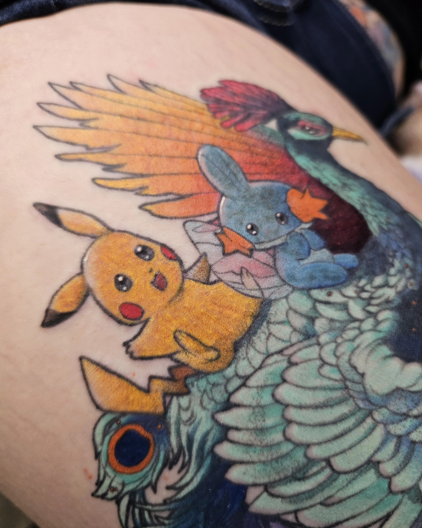 Peacock and Pikachu new school tattoo on the thigh by Nikki 💀🌿