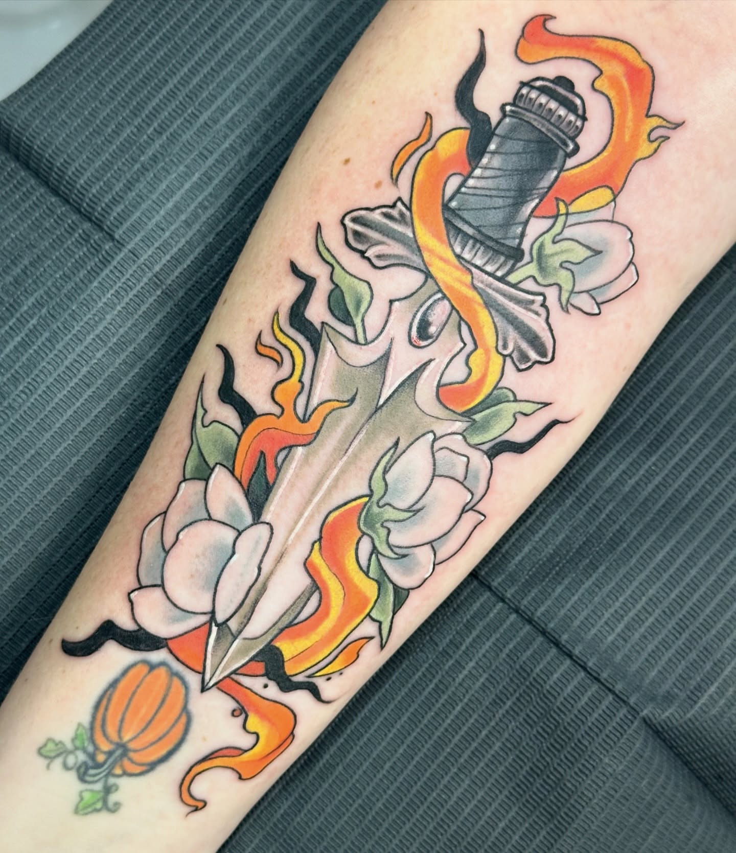 Sword and flowers American traditional tattoo on the forearm by Sarah Bobby, Houston, Texas