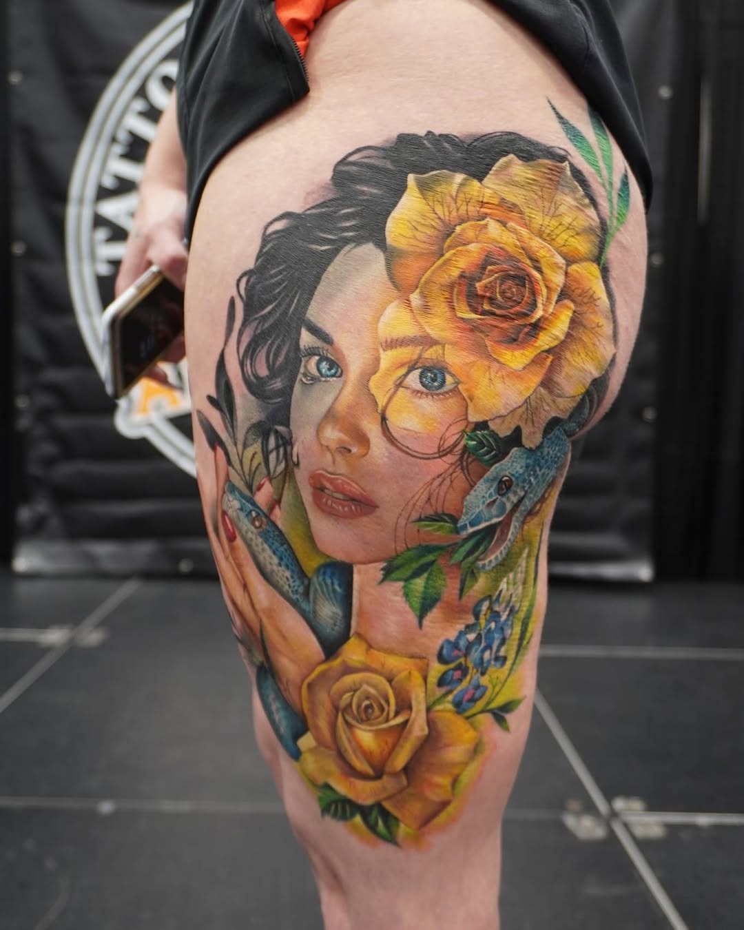 Woman with snakes and roses neo-traditional tattoo on the thigh by Su Kang