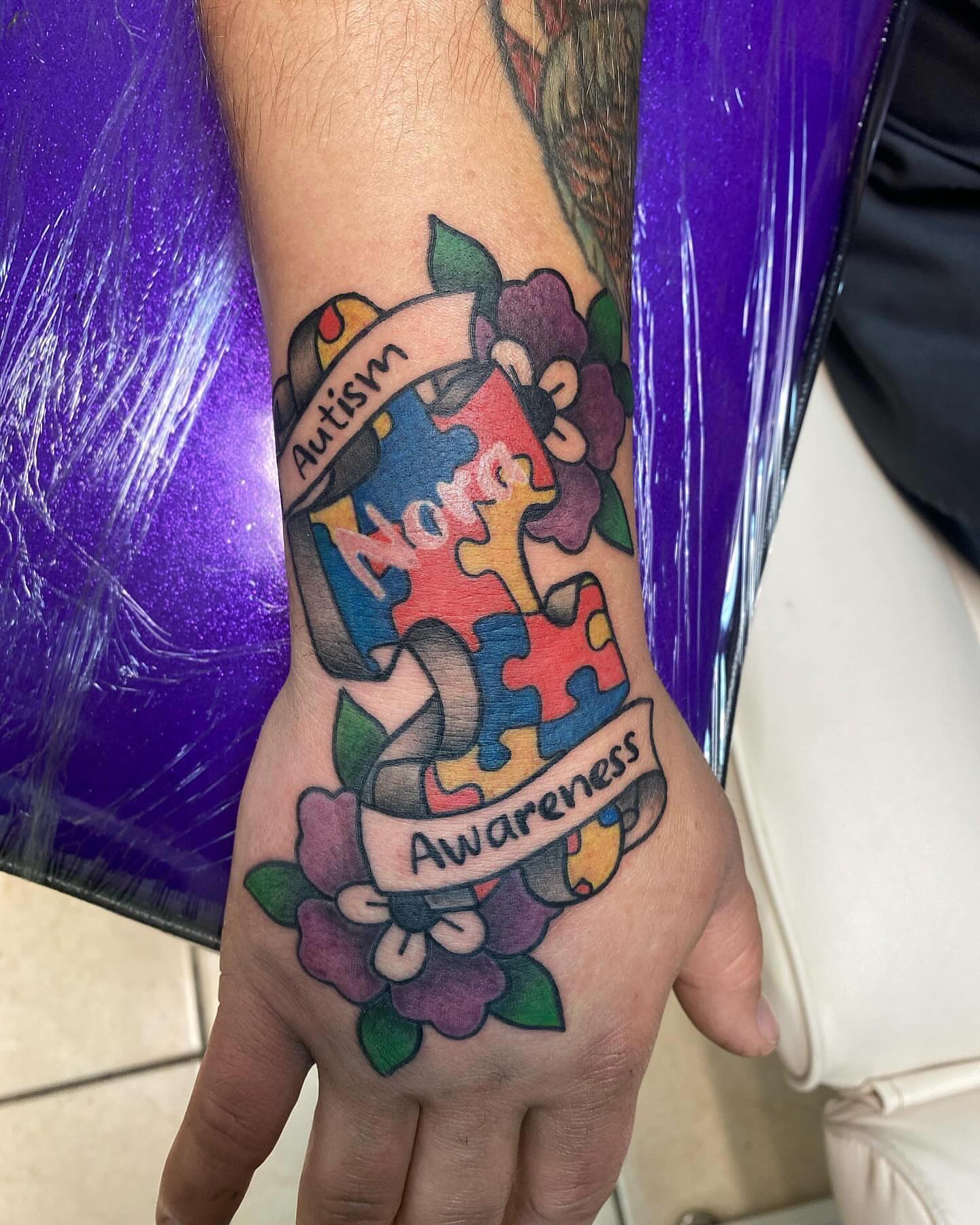 Autism awareness geometric tattoo on the hand by Drew