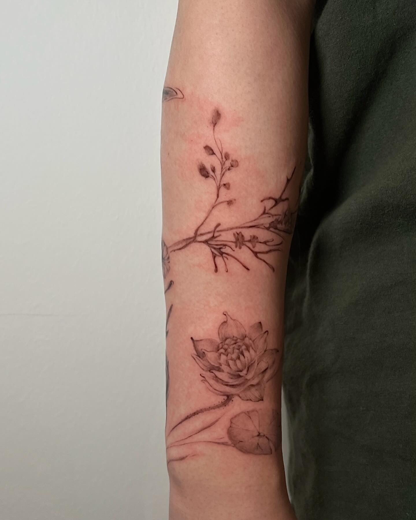 Lotus flower black and grey tattoo on the forearm by G̵̨̗̗̈̅̓́͡ĕ̸̡̜̫̾̌̎̈͠ë̷̢̳̤̰̗͈̃͌͒̚͞