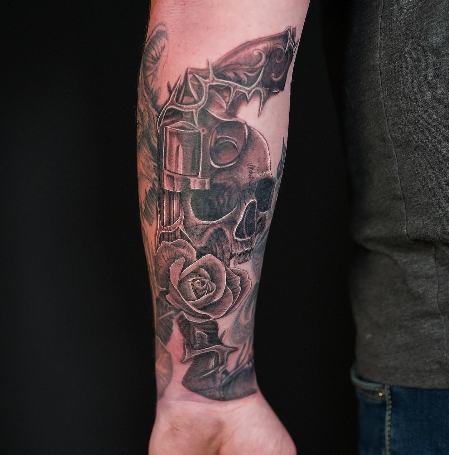 Skull and rose realism tattoo on the forearm by Chris Lochbihler