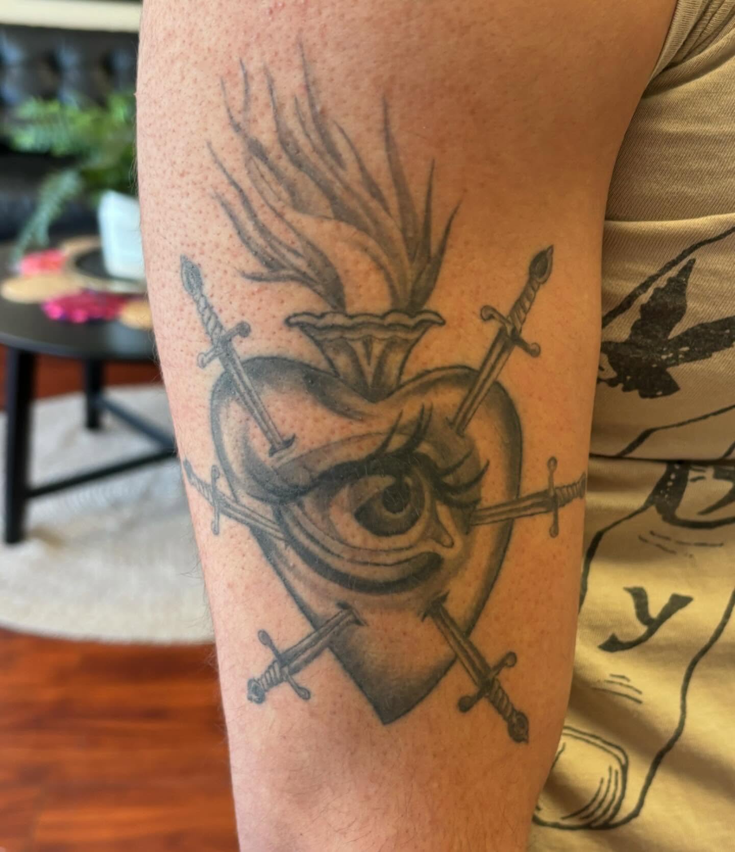 Eye with swords black and grey tattoo on the forearm by Amy Kolton