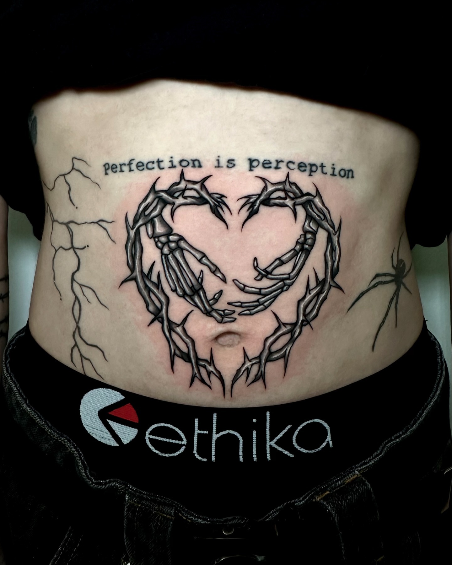 Heart with thorns dark realism tattoo on the ribs by ✮ Monarch Tattoos ✮