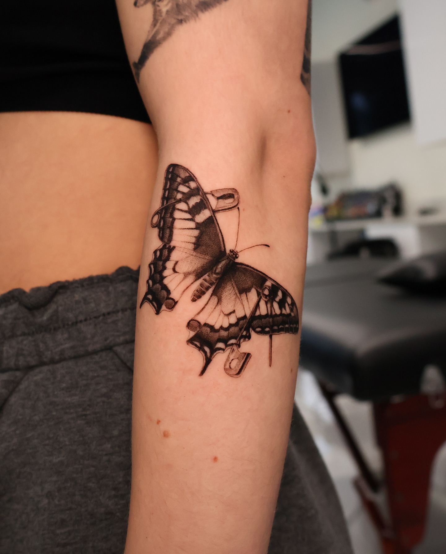 Butterfly black and grey tattoo on the forearm by Riley K Turner