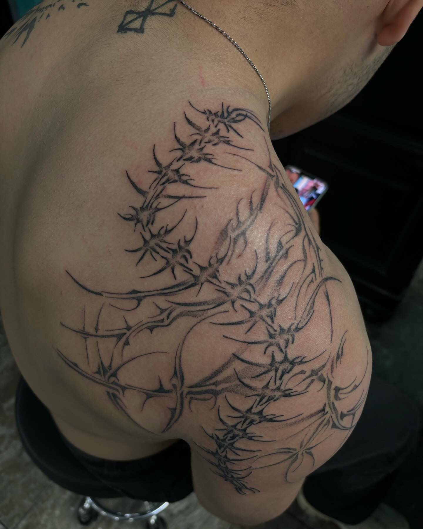 Barbed wire black and grey tattoo on the shoulder by Ares Rhodes