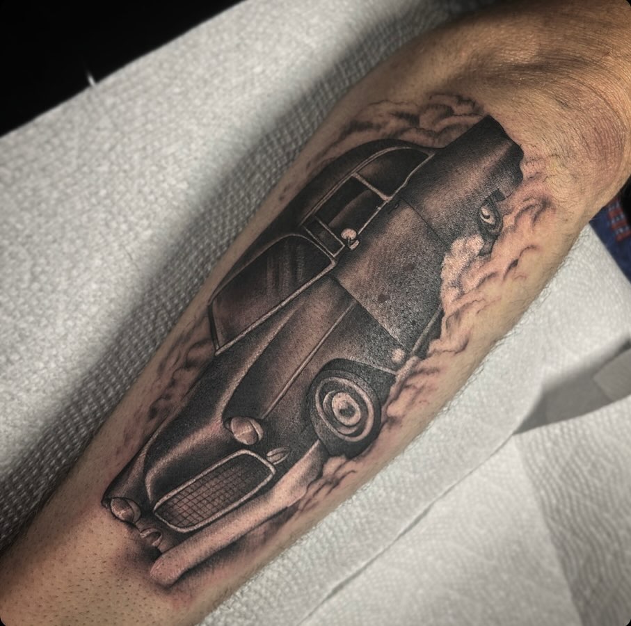 Classic car realism tattoo on the forearm by Lena Lawrence