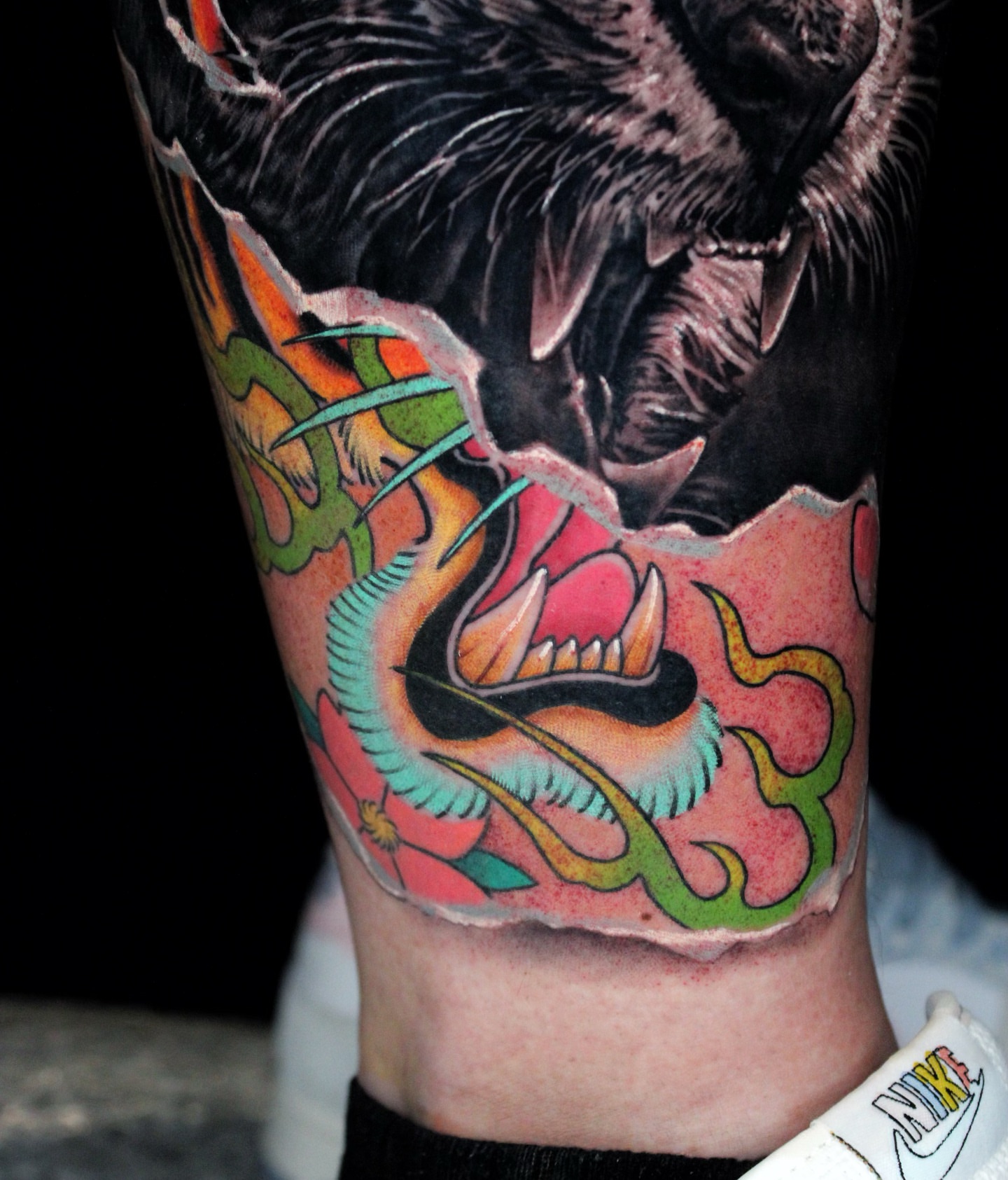 Wolf and dragon American traditional tattoo on the forearm by Mitch Bonifay