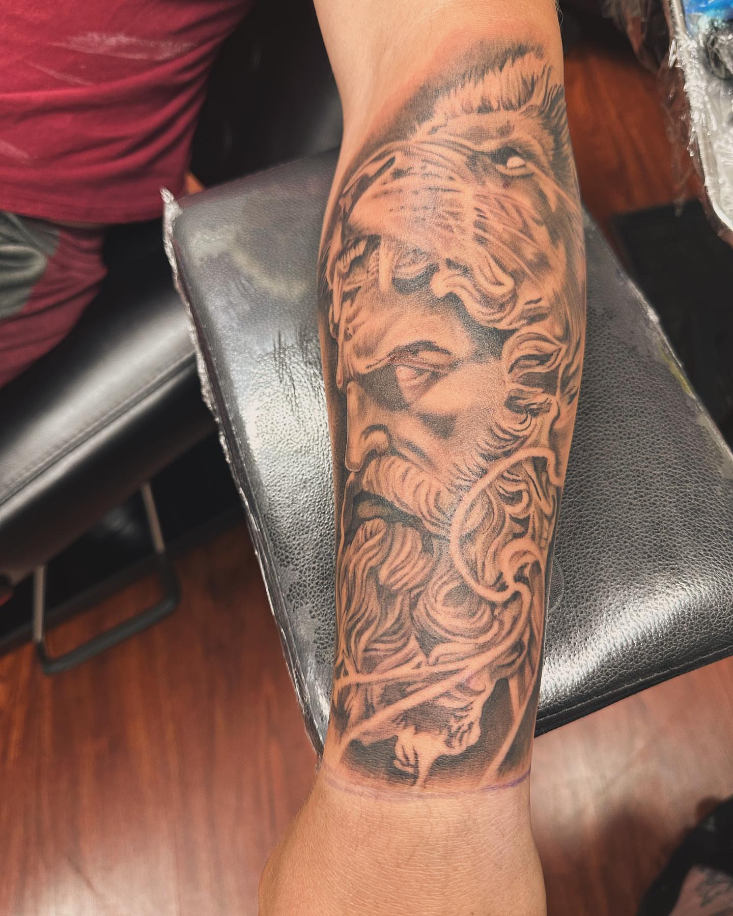 God-like figure realism tattoo on the forearm by Kat π