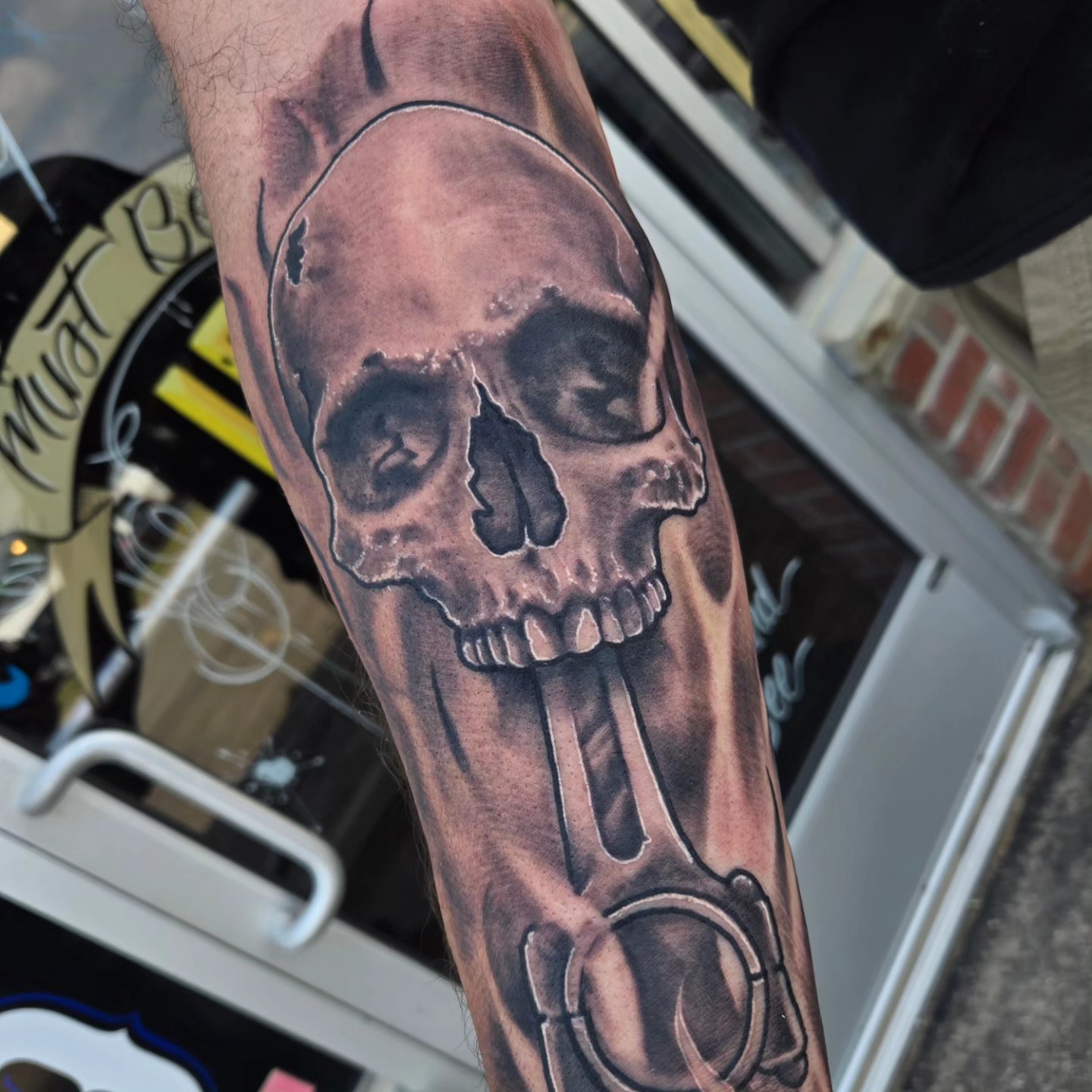 Skull and handcuffs realism tattoo on the forearm by David Johnson
