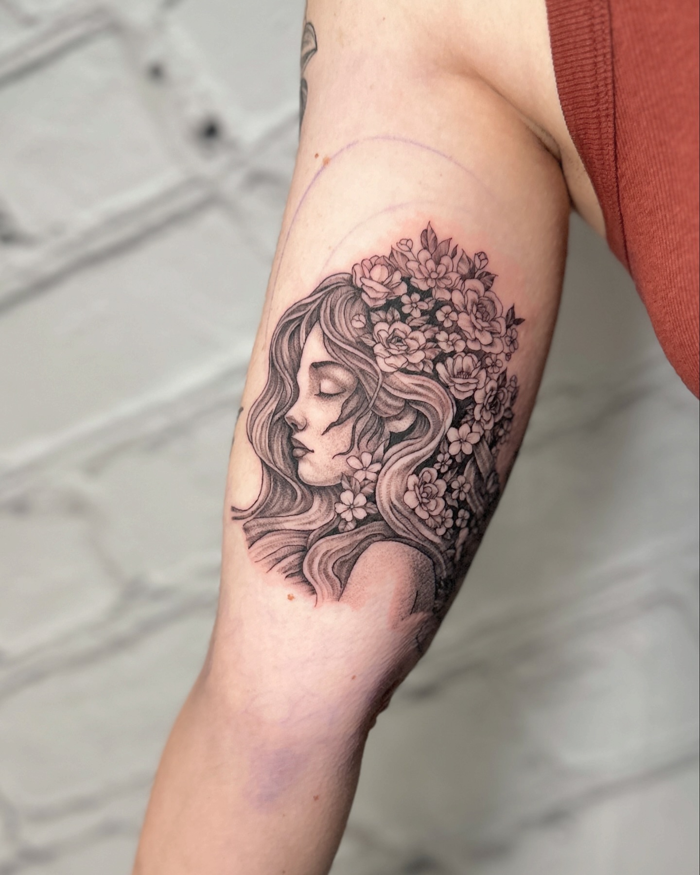 Floral woman realism tattoo on the forearm by Stephen Hansen