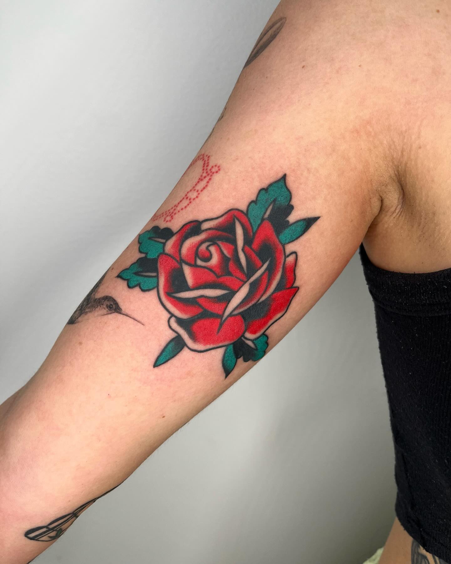 Red rose American traditional tattoo on the forearm by zach arlan, Kansas City, Missouri