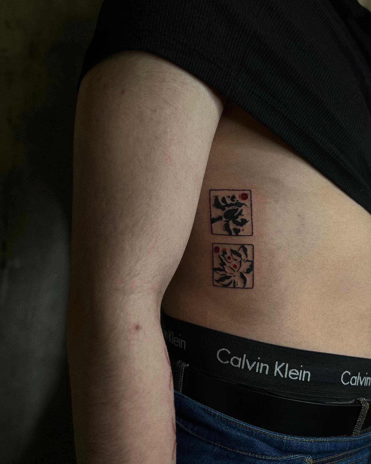 Floral design black and grey tattoo on the ribs by San Kang