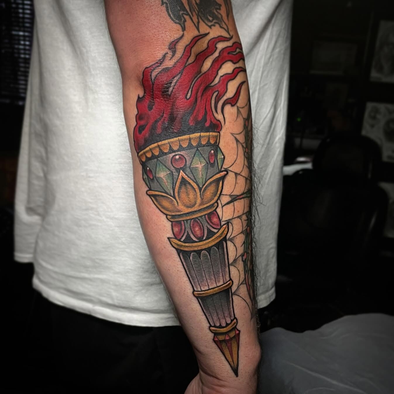 Torch with flames American traditional tattoo on the forearm by JoDee Yates