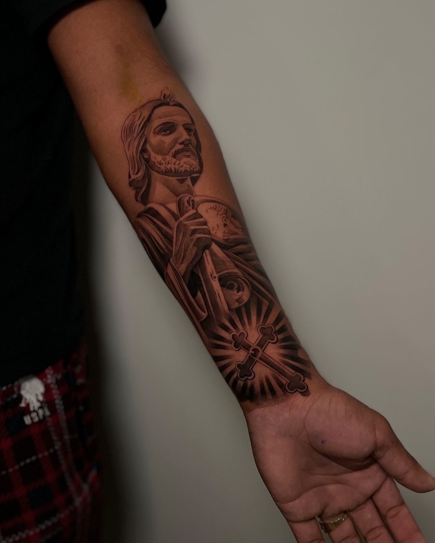 Religious figure black and grey tattoo on the forearm by Vanessa Valdivia