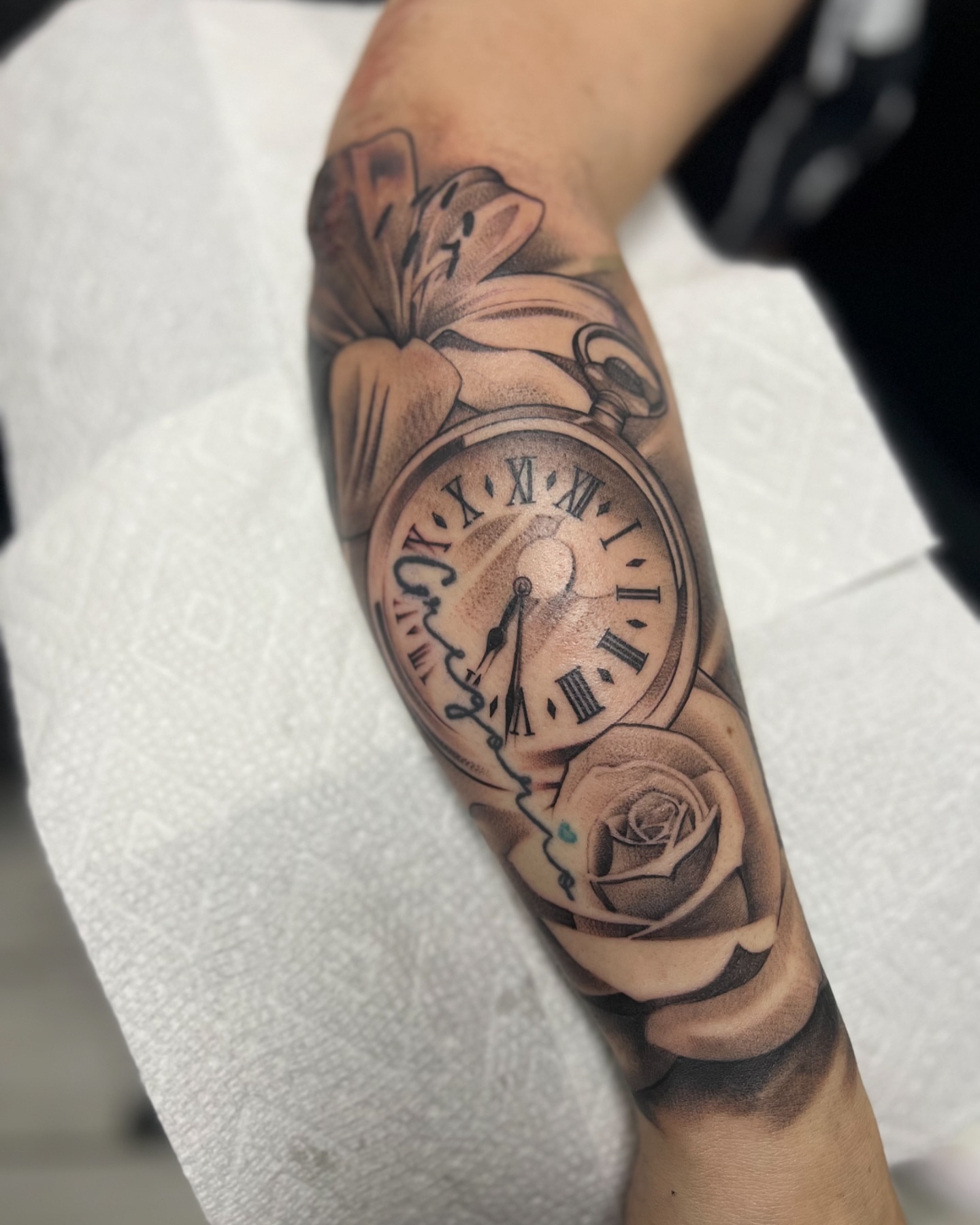 Clock and rose realism tattoo on the forearm by chris tattoo