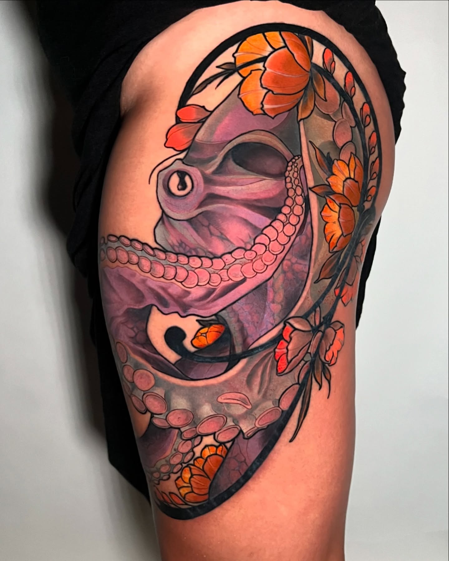 Octopus and flowers American traditional tattoo on the thigh by Joshua Weeks