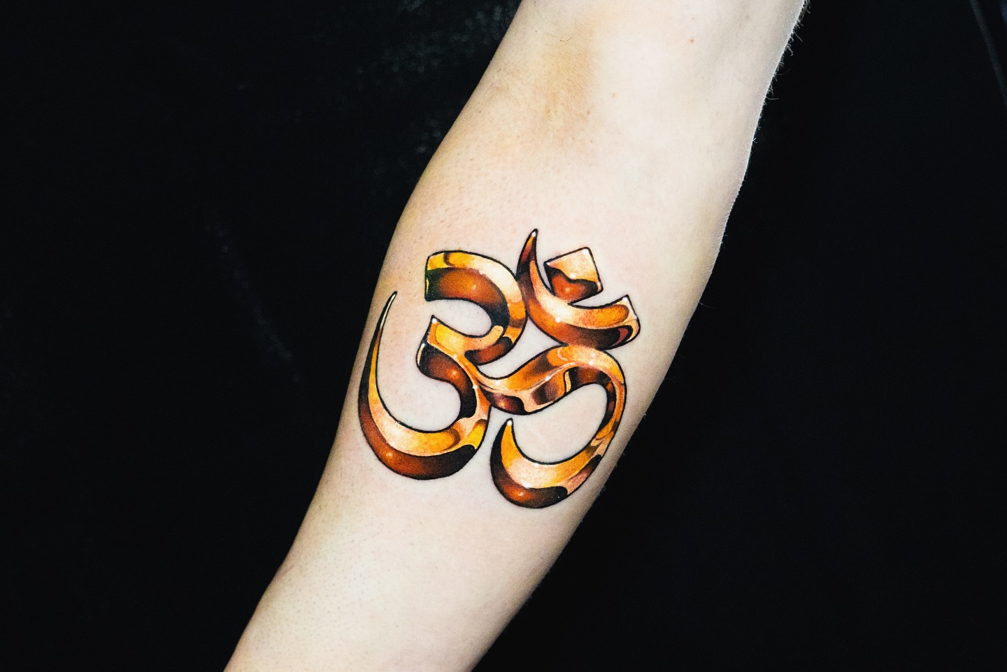 Om symbol new school tattoo on the forearm by James Jurado