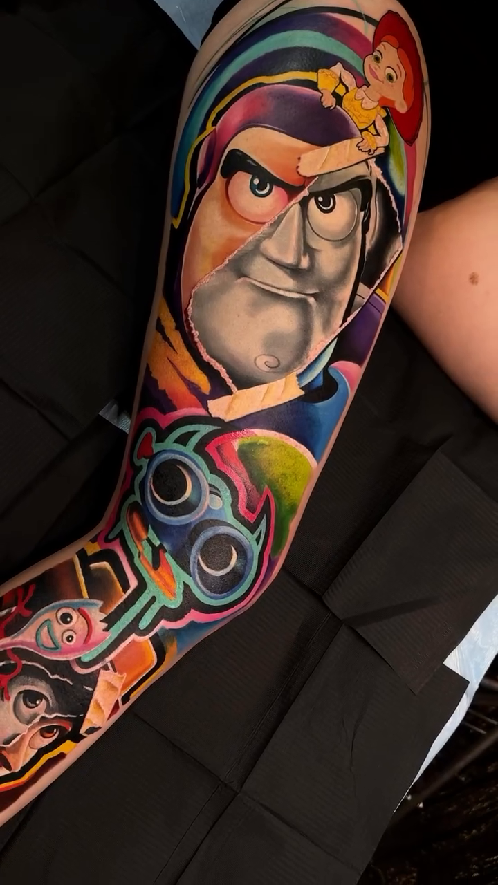 Buzz Lightyear and other characters new school tattoo by Kevin Bradley Jr, Mesa, Arizona