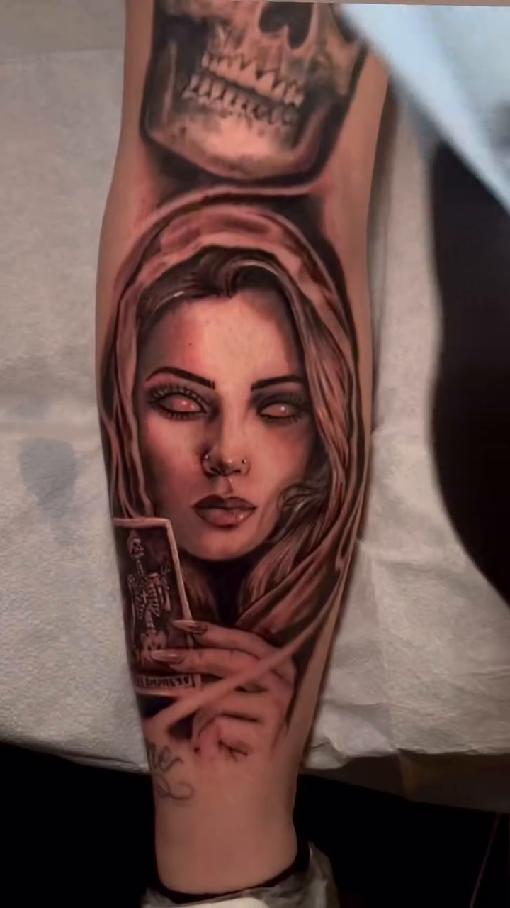 Woman holding tarot card realism tattoo by Greg West Sac tattoo artist, West Sacramento, California