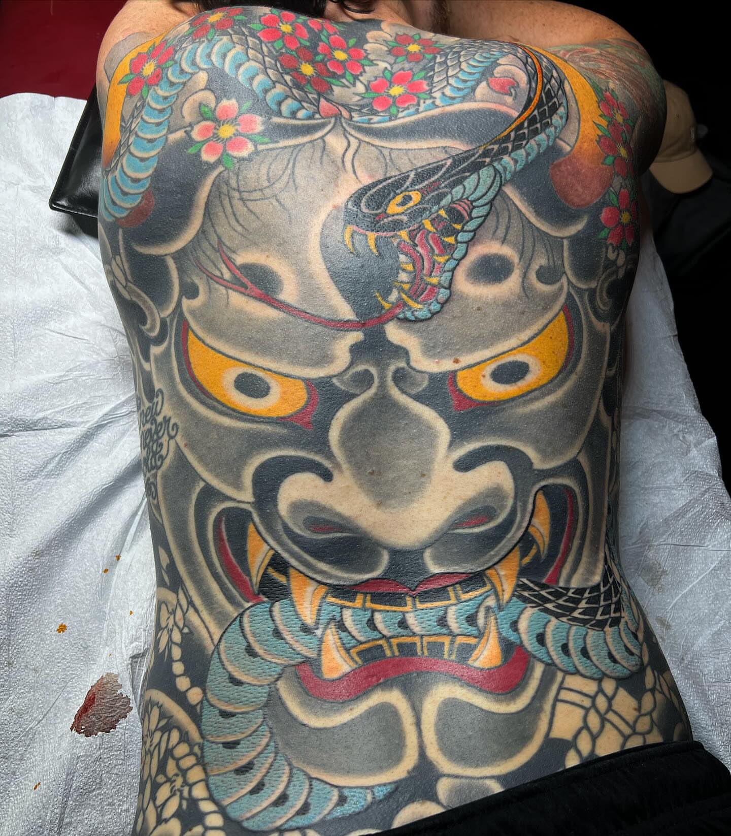 Mask japanese irezumi tattoo on the back by Kayle Leogrande